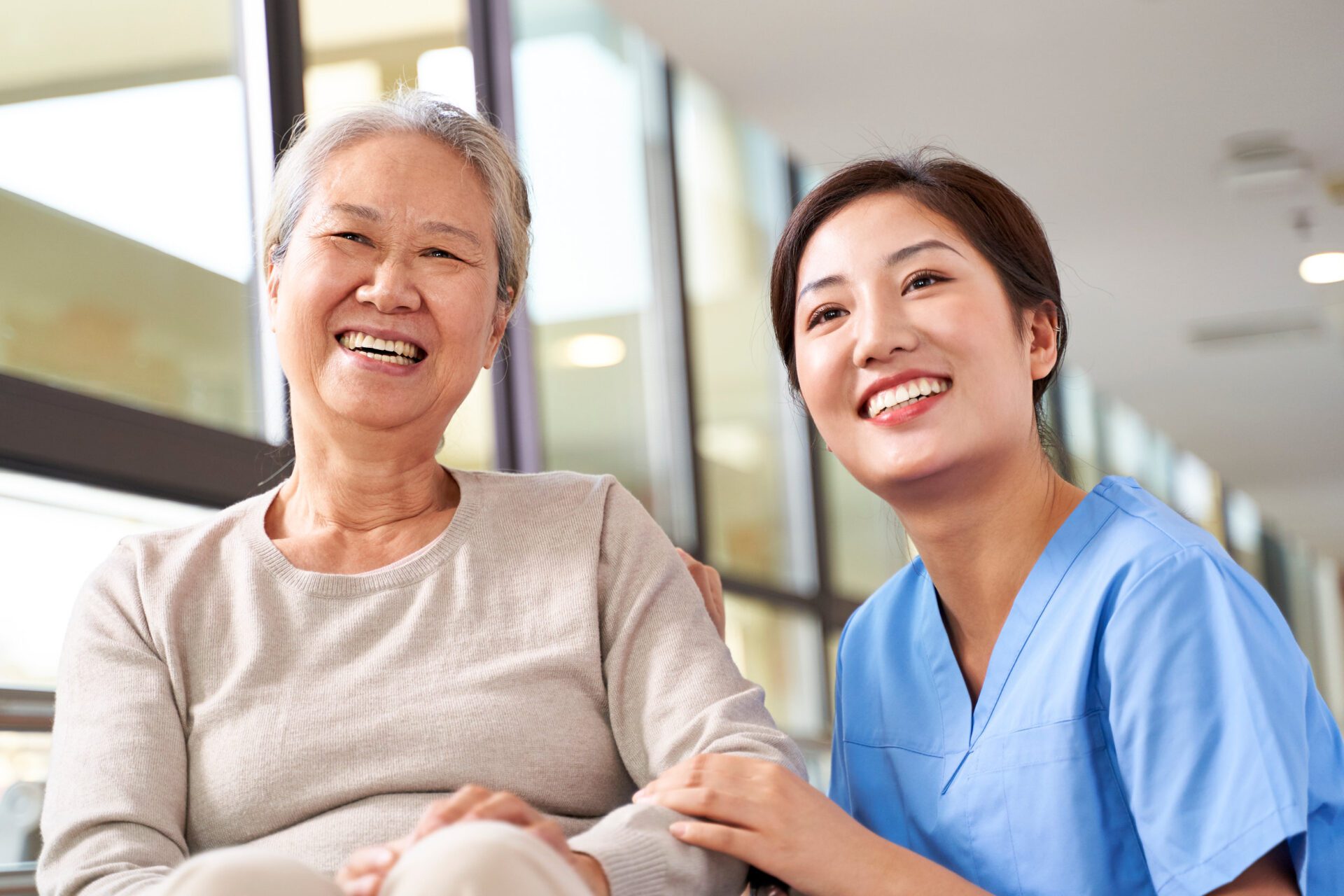 portrait of happy nursing home resident and caregiver